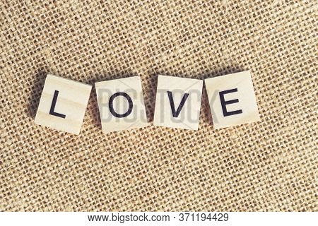 Top View Love Word Written On Wood Block. Love Wood Word With Copy Space.
