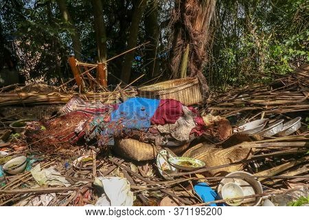 Human Remains Wrapped In Colored Cloth. Decomposing Bodies Lie On The Surface. Traditional Way Of Bu