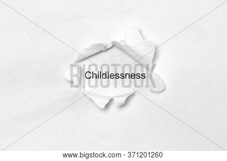 Word Childlessness On White Isolated Background, The Inscription Through The Wound Hole In Paper. St