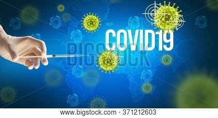 Close-up view of doctor's hand in a white glove holding syringe with COVID19 inscription, coronavirus antidote concept