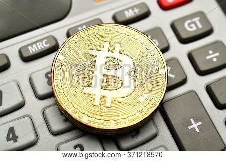 Close Up Of Digital Asset Cryptocurrency Bitcoin On Calculator.
