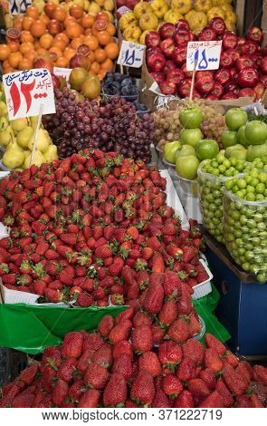 Organic Fruits In A Traditional Bazaar In Iran. Translation Of Price Tags: Strawberries Of Sanandaj 