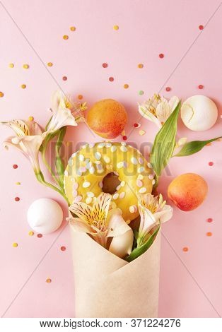 1 Donut With Yellow Icing, French Cookies, Meringues, Fresh Apricots, Alstroemeria Flowers In An Env