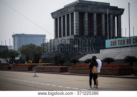 Hanoi, Vietnam - March 5, 2016: A Guy And A Girl Are Walking Near The Ho Chi Minh Mausoleum