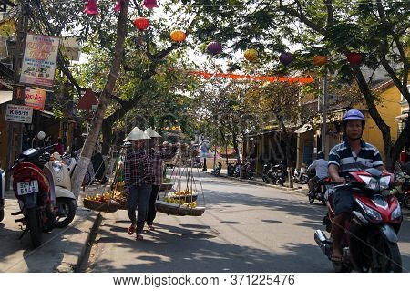 Hoi An, Vietnam - March 20, 2016: Street Vietnames Vendors With Fruits