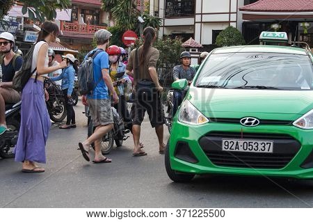 Hoi An, Vietnam - March 20, 2016: Tourists Europeans On The Street Of A Vietnamese City
