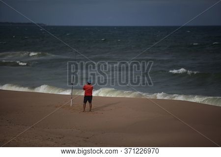 Salvador, Bahia / Brazil - October 4, 2017: Fisherman Is Seen On Empty Beach In The Jardim De Alah R