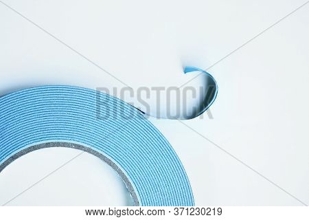 Double Sided Tape Roll On White Background. Two Sided Adhesive Tape In Blue Color