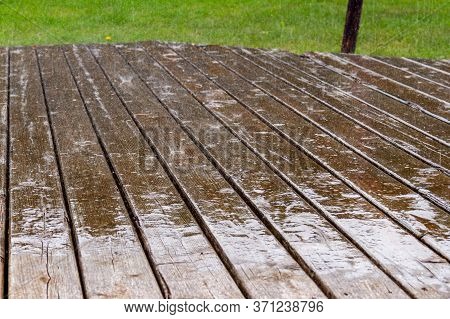 Rain Falling On Wooden Terrace And Creating Splashes