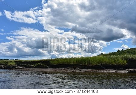 Amazing Landscape With Marsh Grass And A Tidal River.