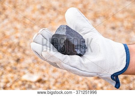 Miner Hand Holding Iron Stone, Metallic Iron Pyrite, Steel, Used In Heavy Industrial Production. Min