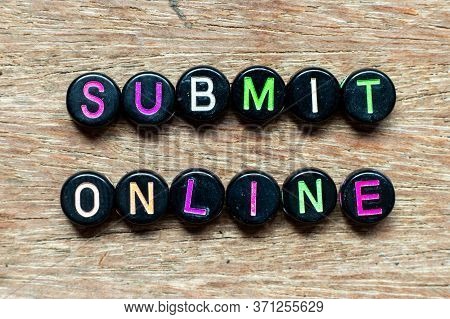 Black Bead With Color Letter In Word Submit Online On Wood Background