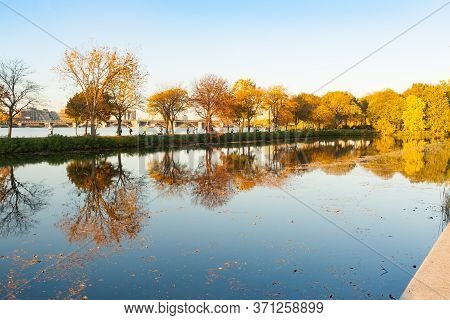 Charles River And City Beyond Storrow Lagoon Reflecting Autumn Tones From Trees In Clam Lagoon Water