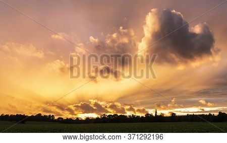 Beautiful Summer Sunset Sky With Heart Shaped Cloud And Colorful Vibrant Clouds And Sun Beams Across