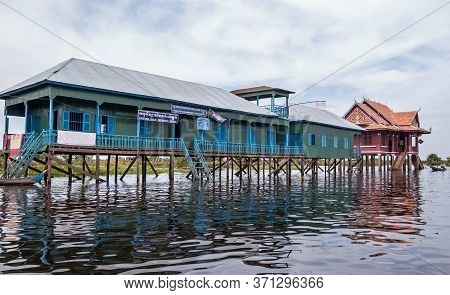 Kampong Phluk, Cambodia - December 4, 2011:  Town School And Fishery Office Built On Stilts In The T