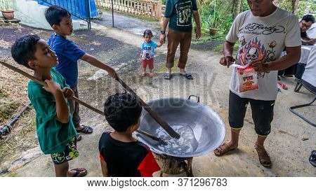 Cooking Traditional Malaysian Sweet Desert, Dodol By The Villagers During Hari Raya.