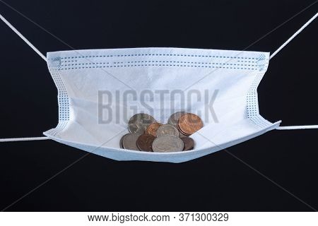 Medical Face Mask And Money On A Black Background. World Coronavirus Epidemic And Economic Losses Co
