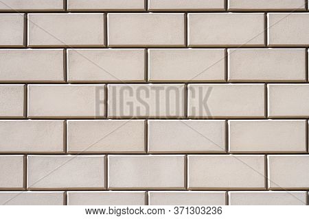 Background From A Wall With Rectangular Beige Stone Slabs