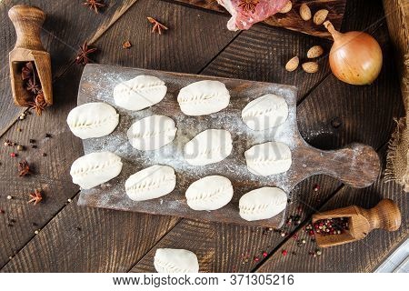 Top View On Semi-finished Manti Dumplings On The Wooden Board, Horizontal