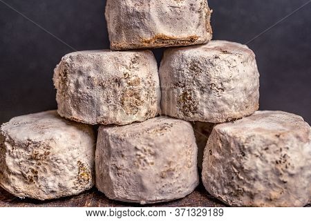 French Cheese Crottin De Chavignol In The Dark Background. High Quality Photo