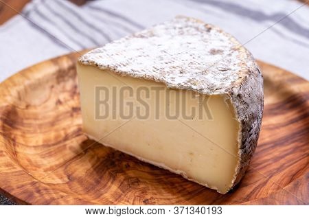 Pieces Of Cheese Tomme De Montagne Or Tomme De Savoie Made From Cow Milk In French Alps.