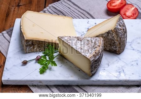 Pieces Of Cheese Tomme De Montagne Or Tomme De Savoie Made From Cow Milk In French Alps.