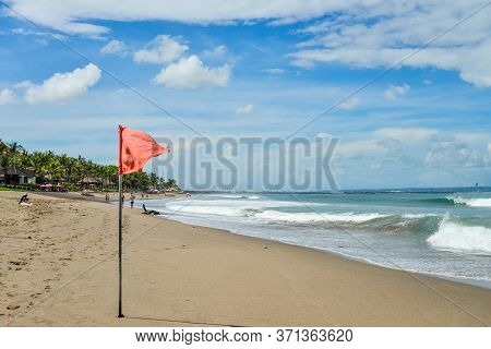 Bali, Indonesia - April 2, 2019 : Petitenget Beach In Seminyak  With Red Flag At Sunny Day, Popular 