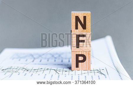 Word Nfp - Non Farm Payrolls - Acronym Concept On Cubes And Diagrams On A Gray Background. Business 