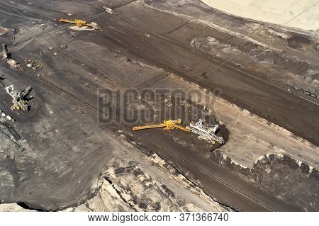 Aerial Shoot Of Quarry With Heavy Bucket Wheel Excavators Mining A Coal. Heavy Industry Concept.