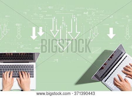 Descending Arrows With People Working Together With Laptop Computers