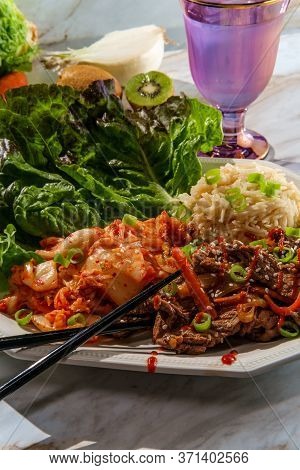 Korean Beef Bulgogi Ssambap Lettuce Wraps With Spicy Kimchi And Gochujang Hot Sauce