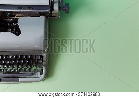 Retro Typewriter On Green Background. Authorship. Journalism. Manual Machine With Keys For Typewriti
