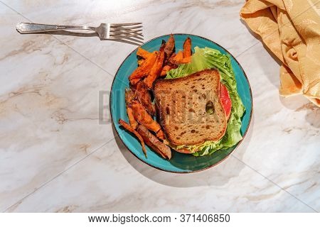 Deli Chicken Guacamole Sandwich On Gluten-free Sliced Bread With Sweet Potato Fries