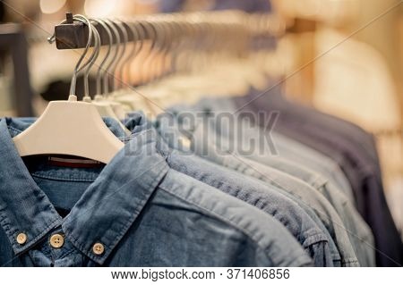 Modern Fashion Women Clothes Hang On Stanless Steel Hangers Rack At Department Store.