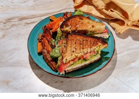 Deli Chicken Guacamole Sandwich On Gluten-free Sliced Bread With Sweet Potato Fries