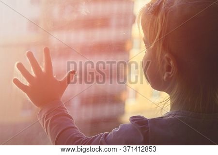 Girl Looks Lonely Through Window By Putting Her Hands On Window Sill
