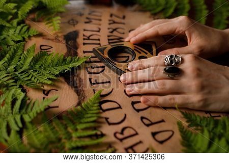 Mystic Ritual With Ouija And Candles. Devil's Board Concept, Black Magic Or Fortune Telling Rite Wit