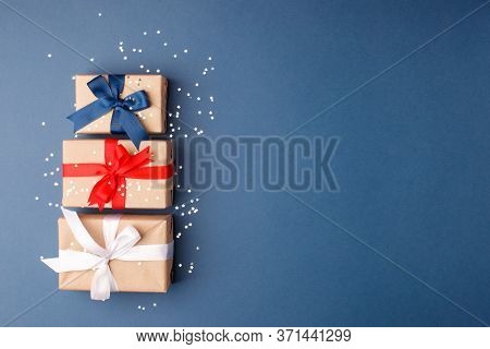 Red, Blue And White Gift Boxes On Classic Blue Background In The National Colors Of America, Russia,