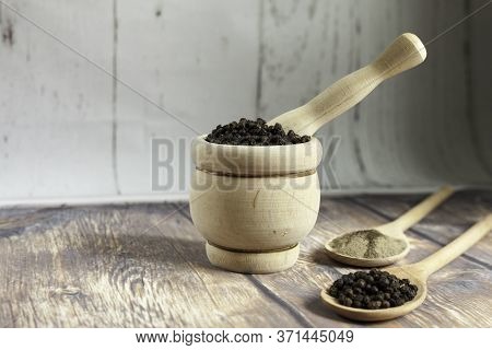 Wooden Mortar Filled With Peppercorns