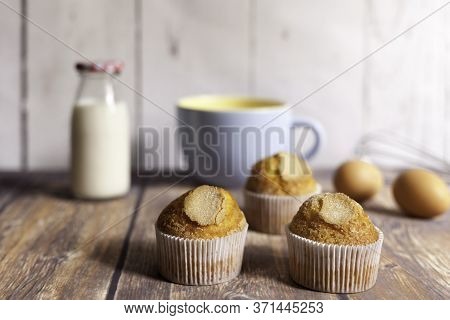 Three Delicious Cupcakes And Milk Bottle
