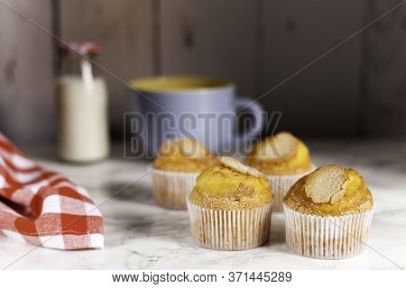 Four Delicious Cupcakes On Wooden Background
