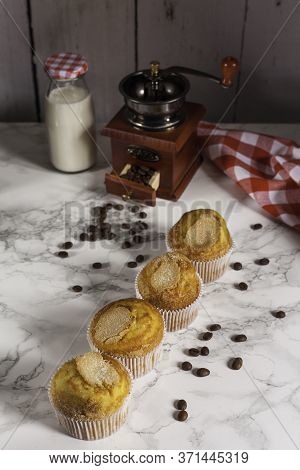 Delicious Cupcakes In Line, Milk Bottle And Grinder Coffee