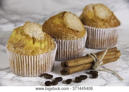 Three Delicious Cupcakes On Marble Background
