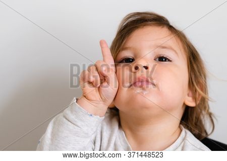 Toddler With One Finger Upwards. Girl Child Portrait Close Up. Lifestyle Math Learning In Preschool