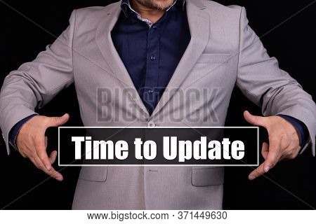 Time To Update. Man Holding An Icon With A Message Text Written On It.