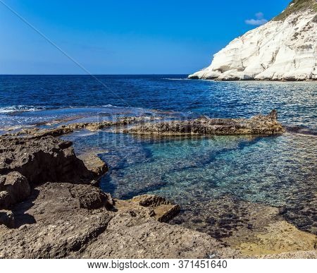  The color of sea water from azure to dark blue. Rocky bay near chalk mountain Rosh a Nikra in northern Israel. The border between Israel and Lebanon. The concept of eco and photo tourism