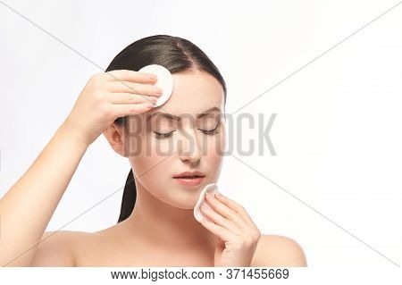Young Girl Remove Mascara From Face. Skin Care With Cotton Pad.
