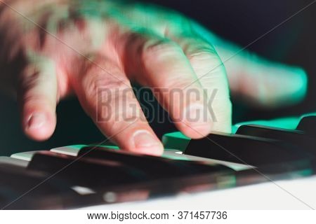 Hand And Fingers Of A Pianist Or Keyboardist Of A Rock Band Close Up Playing A Synthesizer Or Piano.