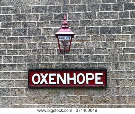 Oxenhope, England - June 24:  A Destination Sign And Traditional Lantern At Oxenhope Station On The 