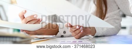Focus On Tender Female Hands Holding Important Business Documents With Significant Charts And Graphs